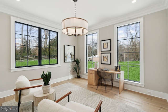 office area featuring light wood-type flooring and ornamental molding