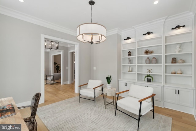 sitting room featuring light wood-type flooring and crown molding