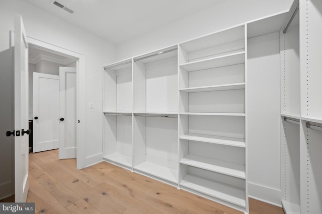 spacious closet with hardwood / wood-style floors