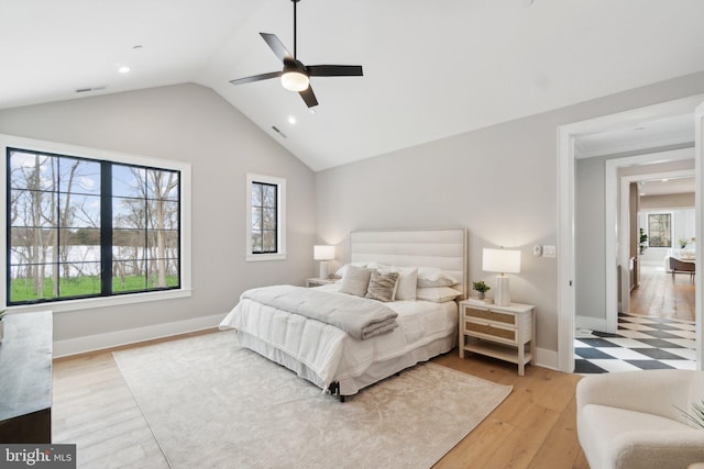 bedroom with vaulted ceiling, light wood-type flooring, and ceiling fan