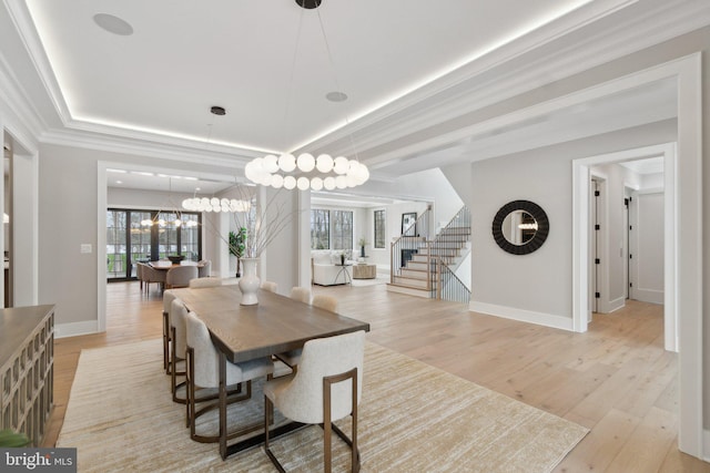 dining area with crown molding and light hardwood / wood-style flooring