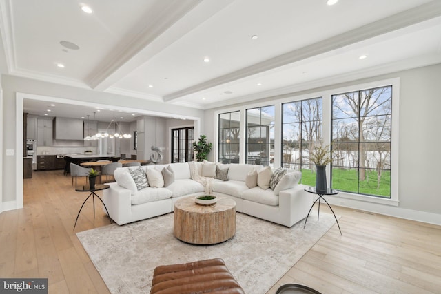 living room with a wealth of natural light, light wood-type flooring, ornamental molding, and beamed ceiling