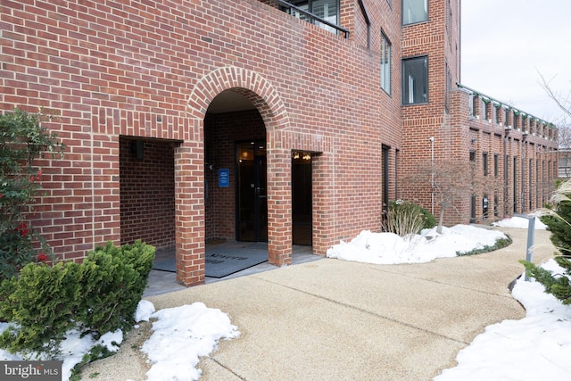 view of snow covered property entrance