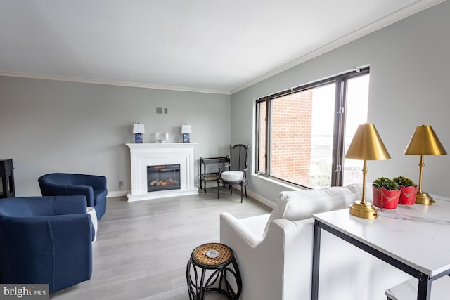 living room with crown molding and light hardwood / wood-style floors