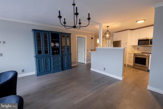 kitchen featuring crown molding, blue cabinetry, appliances with stainless steel finishes, white cabinetry, and decorative light fixtures