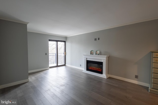 unfurnished living room with ornamental molding and dark hardwood / wood-style floors