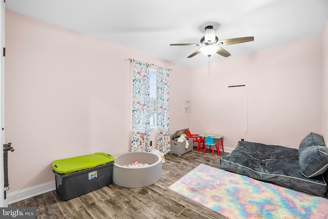 game room featuring wood-type flooring and ceiling fan