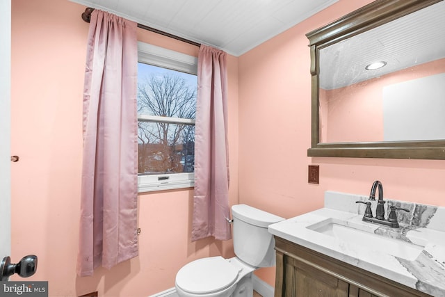 bathroom featuring toilet and vanity