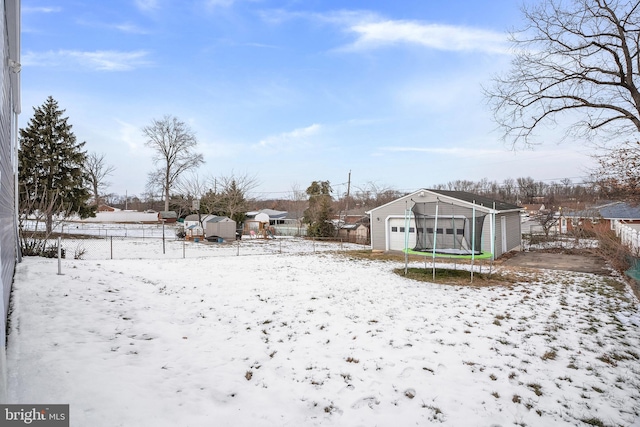 yard layered in snow featuring an outbuilding