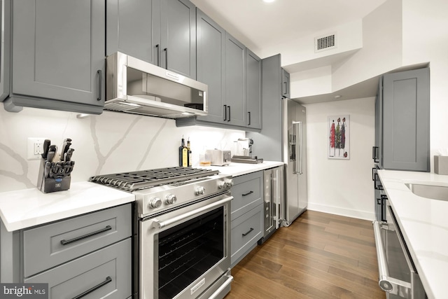 kitchen with appliances with stainless steel finishes, visible vents, and gray cabinetry