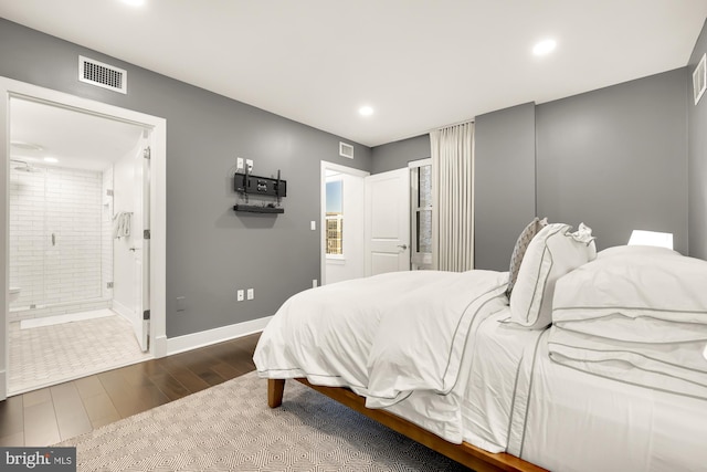 bedroom with recessed lighting, visible vents, ensuite bathroom, dark wood-type flooring, and baseboards