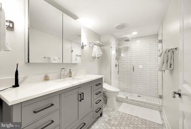 full bath with toilet, tile patterned floors, a shower stall, and vanity