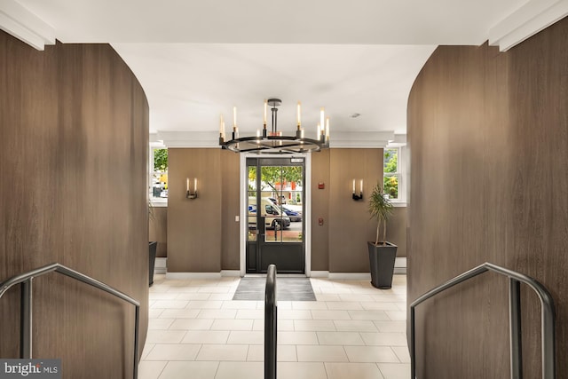 foyer featuring light tile patterned floors and a chandelier