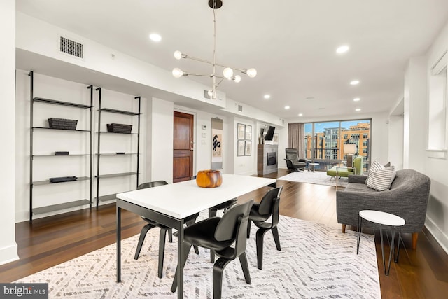 dining space featuring baseboards, visible vents, dark wood finished floors, and recessed lighting