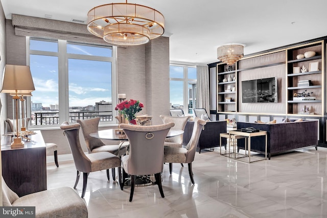 dining room featuring a healthy amount of sunlight and a notable chandelier