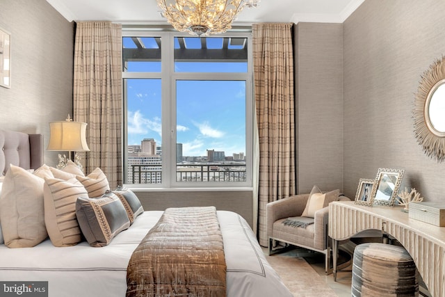 bedroom with ornamental molding and a notable chandelier