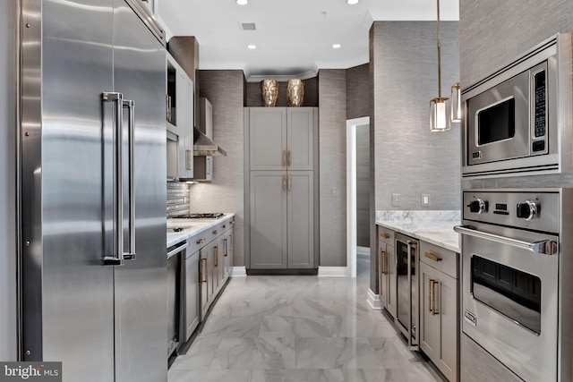 kitchen featuring gray cabinets, wine cooler, hanging light fixtures, built in appliances, and light stone counters