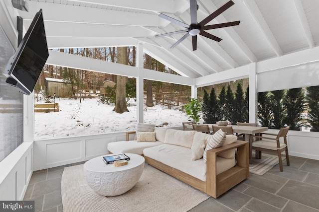 sunroom featuring ceiling fan and lofted ceiling with beams