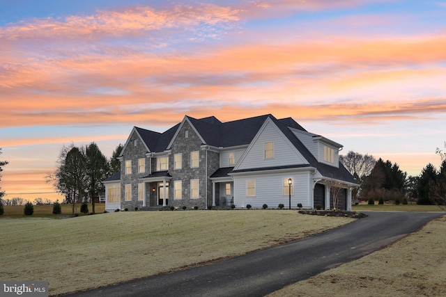 view of front facade featuring a garage and a yard