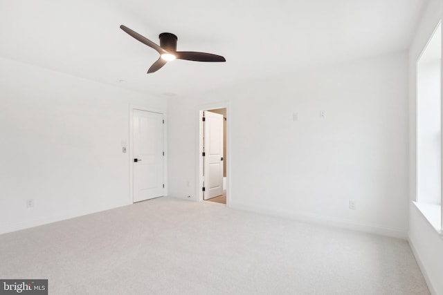 carpeted empty room featuring ceiling fan