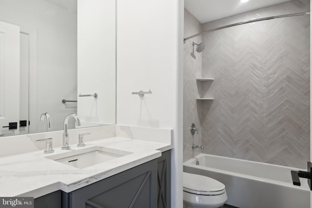 full bathroom with toilet, tiled shower / bath combo, and vanity