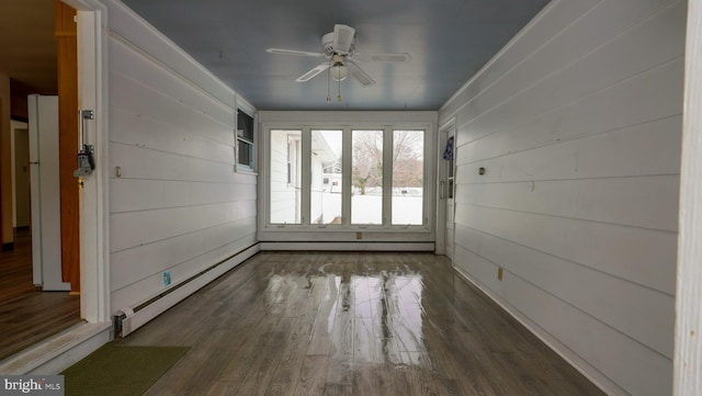 unfurnished sunroom featuring ceiling fan and baseboard heating