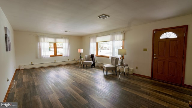 foyer with a baseboard radiator and dark hardwood / wood-style flooring