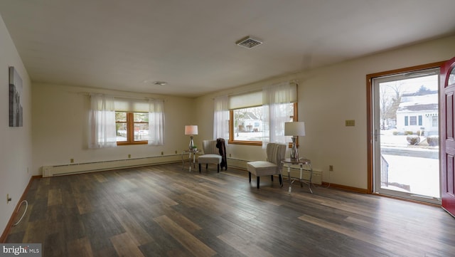 unfurnished room with a baseboard radiator, dark hardwood / wood-style flooring, and plenty of natural light