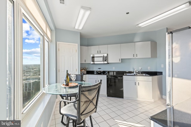 kitchen featuring white cabinetry, dishwasher, sink, and light tile patterned flooring