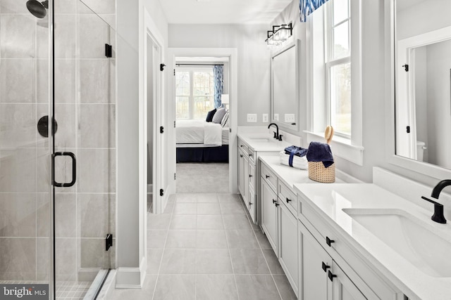 bathroom with walk in shower, tile patterned floors, and vanity