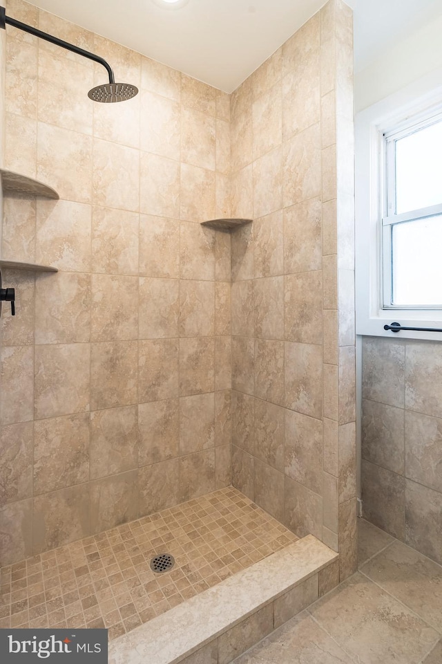 bathroom with a tile shower