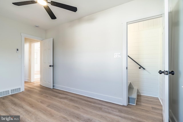 empty room featuring ceiling fan and light hardwood / wood-style floors