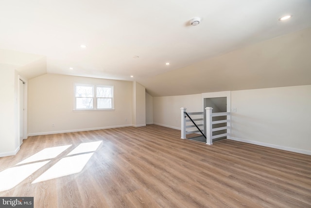 bonus room with lofted ceiling and light hardwood / wood-style flooring