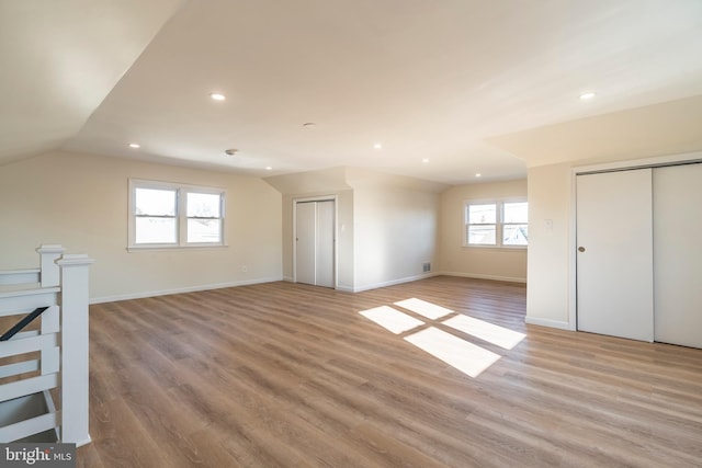 interior space with light wood-type flooring and lofted ceiling