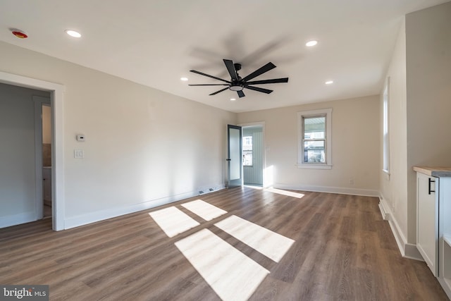 empty room featuring ceiling fan and hardwood / wood-style floors