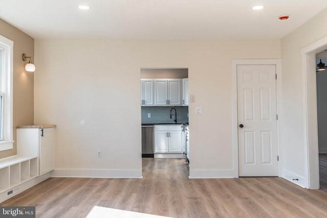 interior space with light hardwood / wood-style flooring and sink