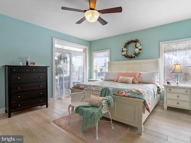 bedroom with ceiling fan and light hardwood / wood-style floors