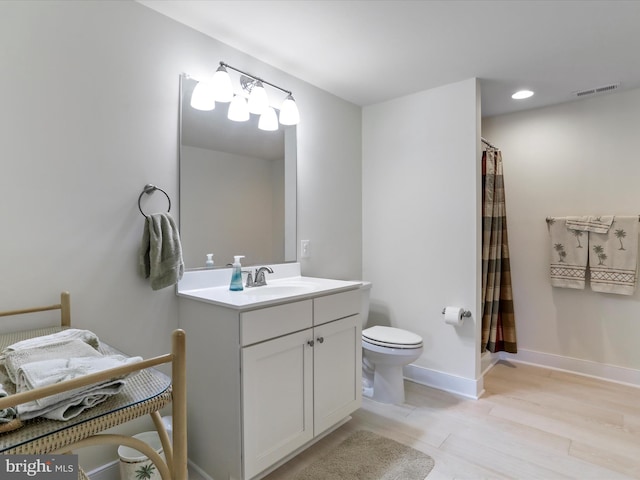 bathroom with toilet, vanity, wood-type flooring, and a shower with curtain