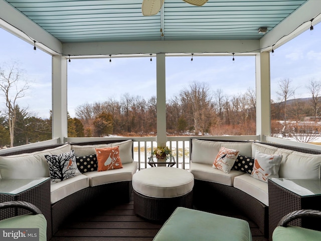 exterior space with ceiling fan and an outdoor living space