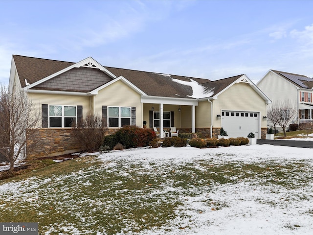 view of front of property featuring a garage and a porch