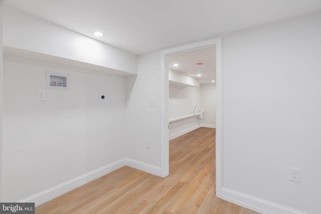 laundry area with light wood-type flooring, washer hookup, and electric dryer hookup