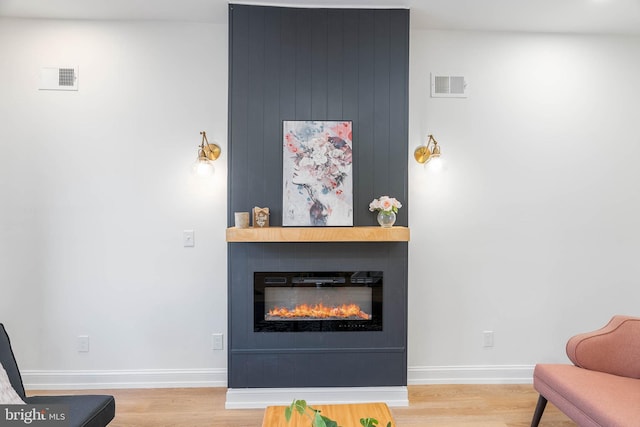 sitting room featuring light hardwood / wood-style floors and a large fireplace