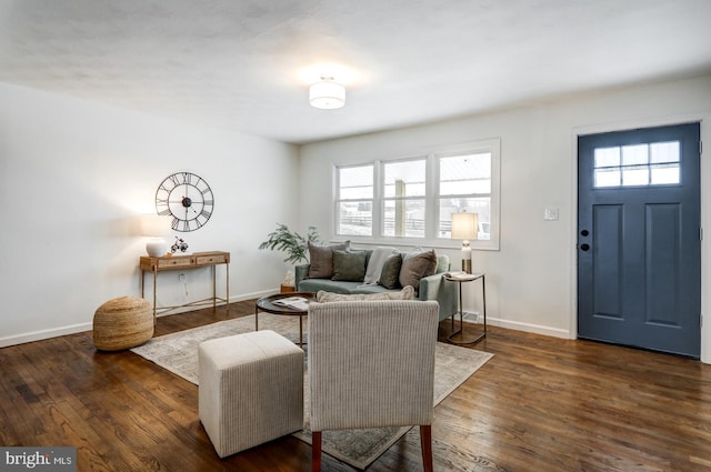 living room with a wealth of natural light and dark hardwood / wood-style flooring