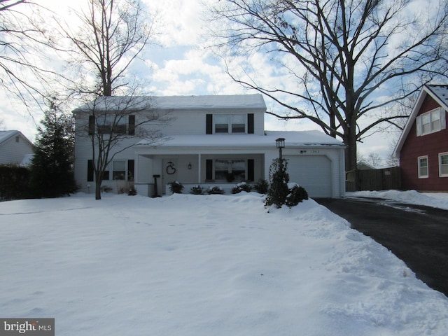 front of property featuring a garage and covered porch