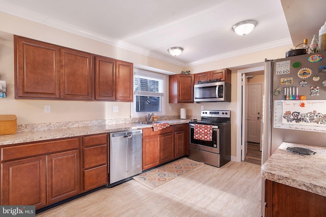 kitchen with sink, crown molding, and stainless steel appliances