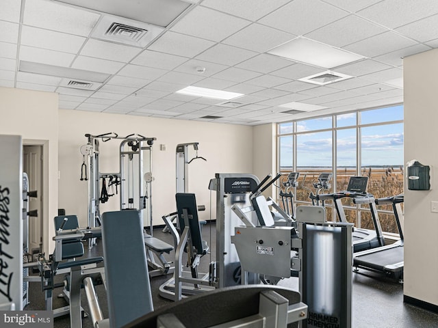 gym with a wall of windows and a paneled ceiling