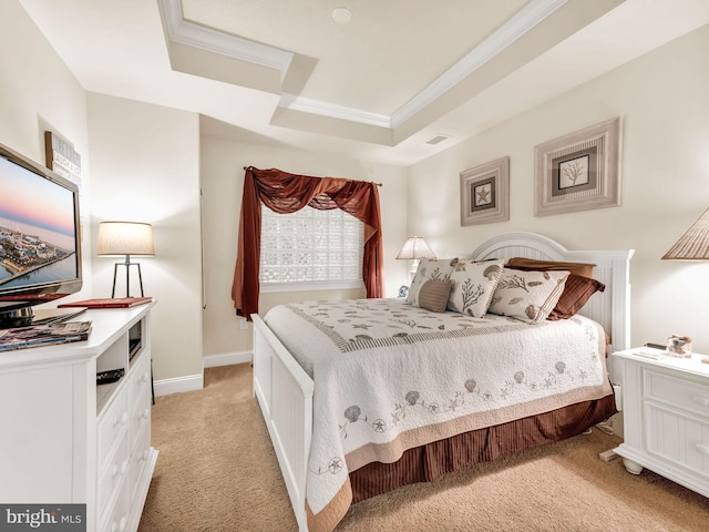 carpeted bedroom with a raised ceiling and crown molding