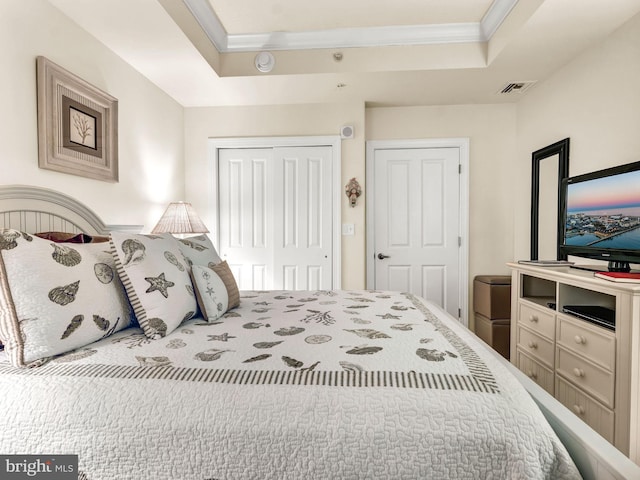 bedroom featuring a raised ceiling and ornamental molding