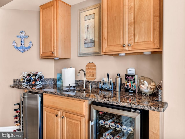 kitchen with sink, dark stone counters, and wine cooler