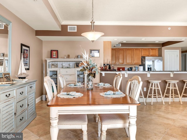 dining area featuring crown molding